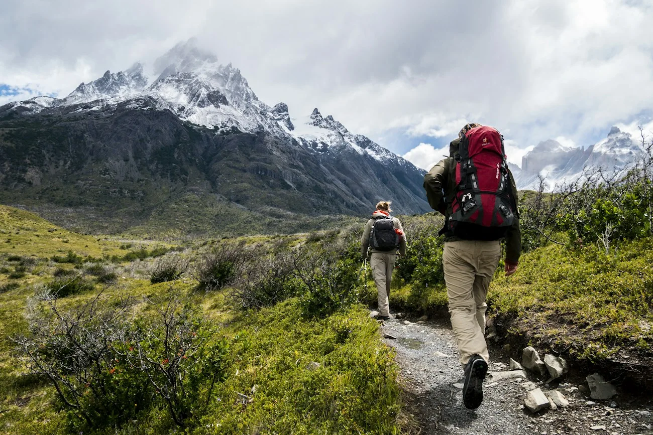 Hikers following a trail through a mountain landscape